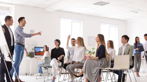 Business trainers giving lecture in office